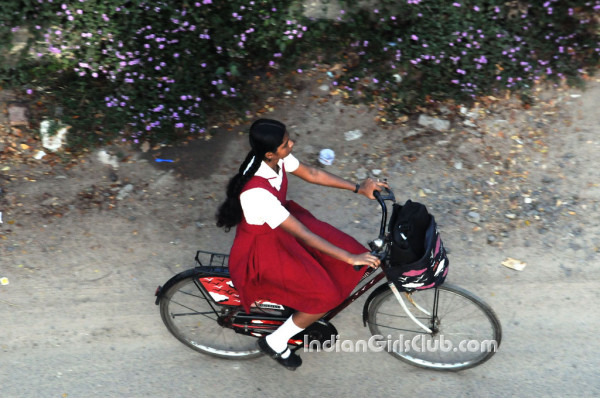 beautiful chennai school girl in uniform riding bicycle to home